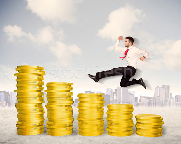 Bem sucedido homem de negócios saltando para cima moeda de ouro dinheiro Foto stock © ra2studio