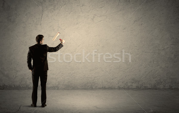 Salesman with roller standing at empty wall Stock photo © ra2studio