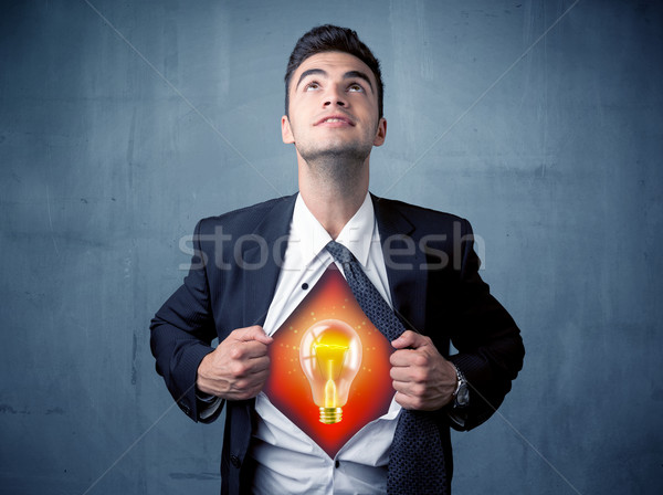 Businessman ripping off shirt and idea light bulb appears  Stock photo © ra2studio