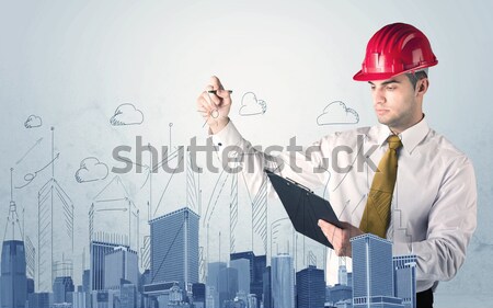 Young worker drawing a city sight Stock photo © ra2studio