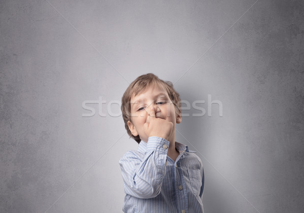 Adorable little boy in front of an empty wall Stock photo © ra2studio