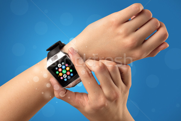 Female hand with smartwatch and app icons Stock photo © ra2studio