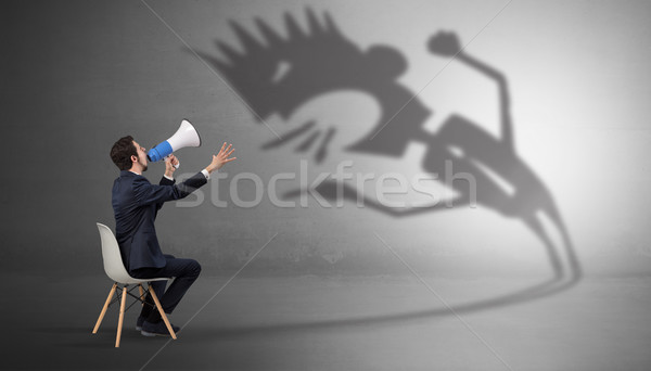 Businessman negotiate with a monster shadow Stock photo © ra2studio