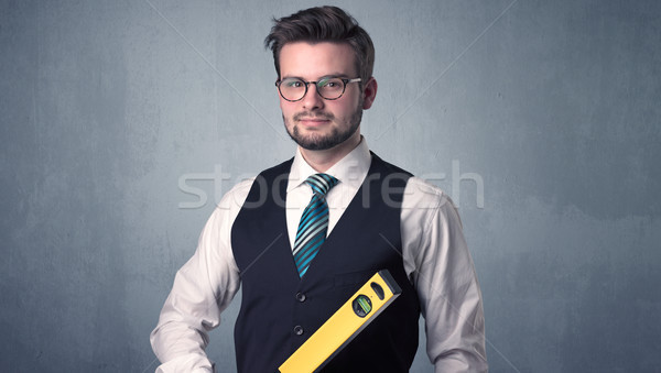 Businesman standing with tool on his hand Stock photo © ra2studio