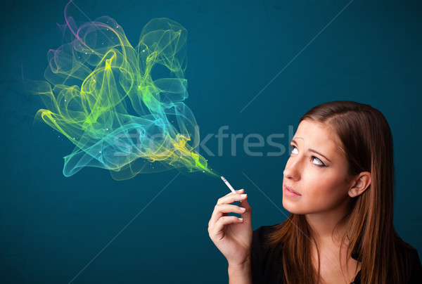 Bastante dama fumar cigarrillo colorido humo Foto stock © ra2studio