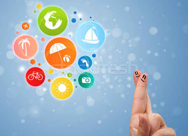 Cheerful happy smiling fingers with colorful holiday travel bubble icons Stock photo © ra2studio