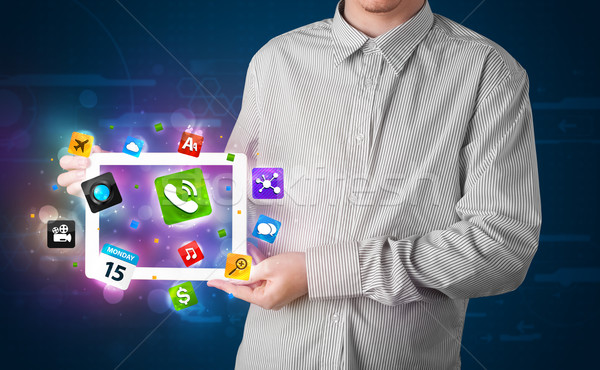 Fiatal üzletember tart tabletta modern színes Stock fotó © ra2studio