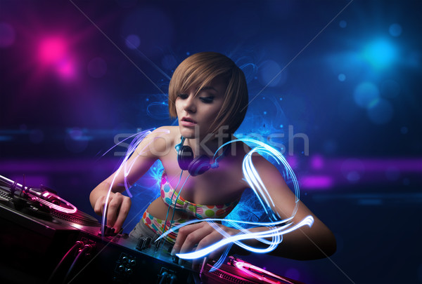 Disc jockey playing music with electro light effects and lights Stock photo © ra2studio