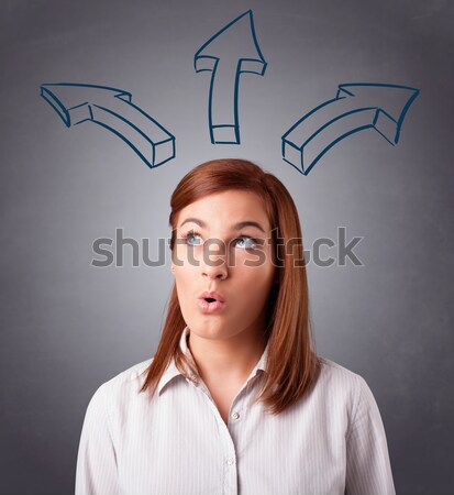 Pretty lady thinking with arrows overhead Stock photo © ra2studio