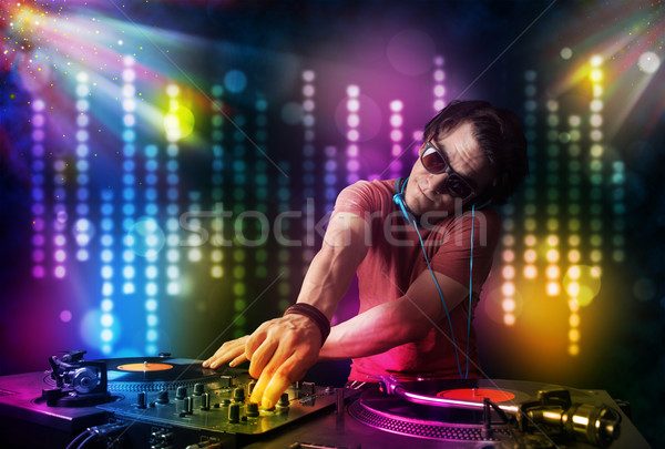 Dj playing songs in a disco with light show Stock photo © ra2studio