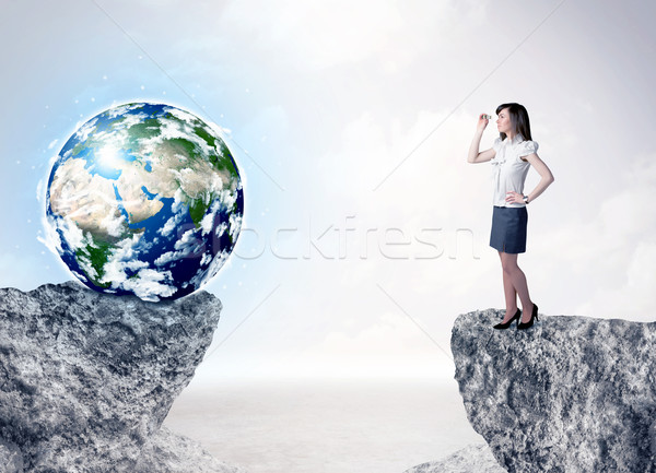 Businesswoman on rock mountain with a globe Stock photo © ra2studio