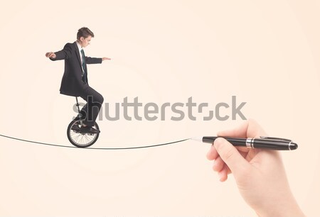 Businessman riding monocycle on a rope drawn by hand Stock photo © ra2studio