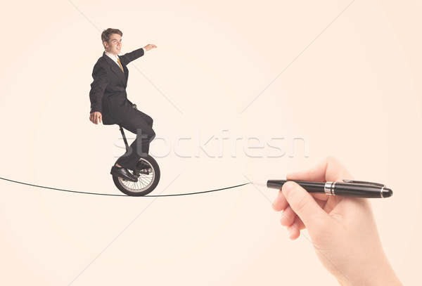 Businessman riding monocycle on a rope drawn by hand Stock photo © ra2studio