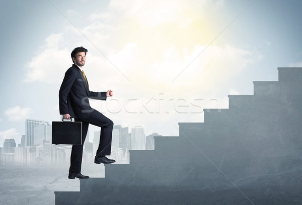 Businessman climbing up a concrete staircase concept Stock photo © ra2studio