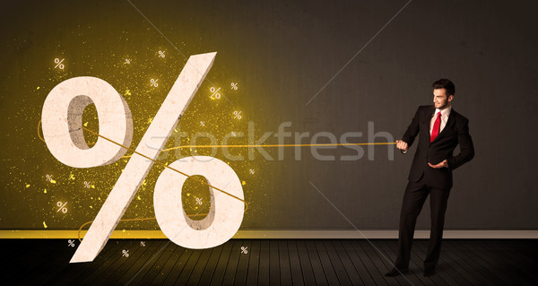 Business man pulling rope with big procent symbol sign  Stock photo © ra2studio