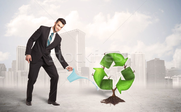 Business man watering green recycle sign tree on city background Stock photo © ra2studio