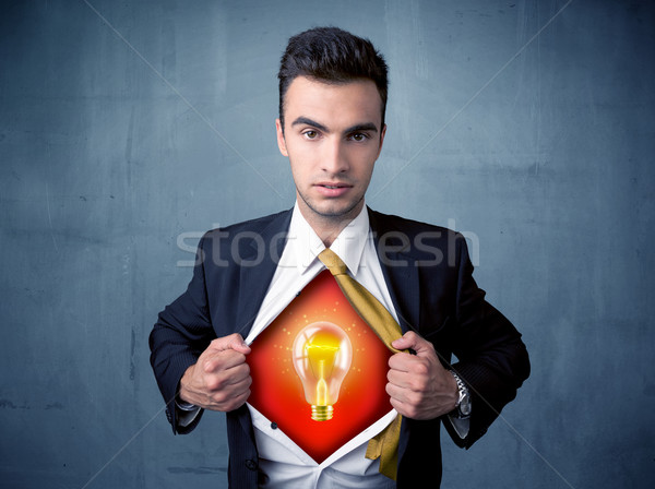 Businessman ripping off shirt and idea light bulb appears  Stock photo © ra2studio