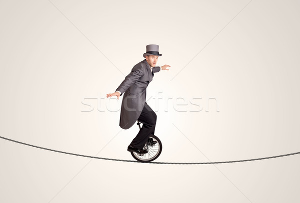 Сток-фото: Extreme · деловой · человек · верховая · езда · одноколесном · велосипеде · веревку · бизнеса