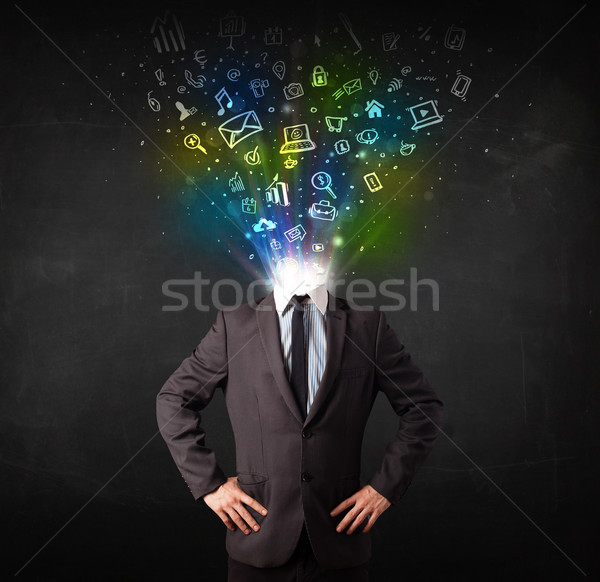 Business man with glowing media icons exploding head  Stock photo © ra2studio