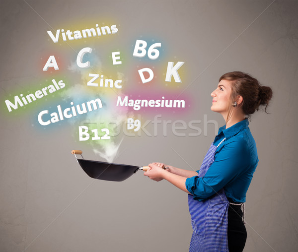 Young woman cooking vitamins and minerals Stock photo © ra2studio