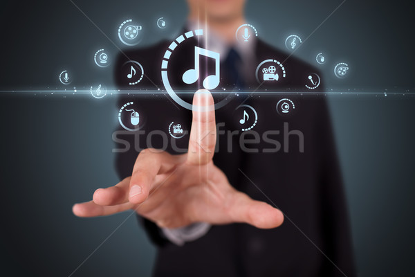 Stock photo: Businessman pressing virtual media type of buttons 