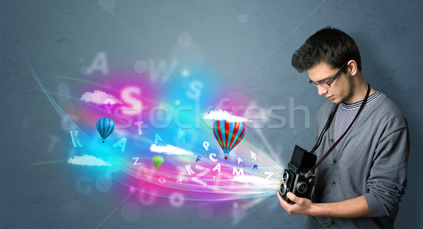 Handsome photographer with camera and abstract imaginary Stock photo © ra2studio