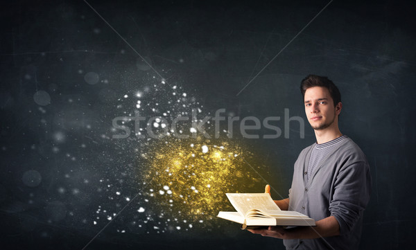 Young guy reading a magical book Stock photo © ra2studio