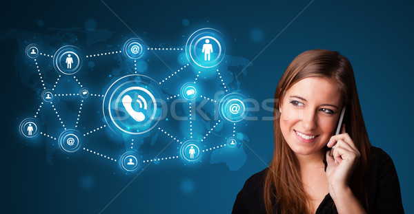 Pretty girl making phone call with social network icons Stock photo © ra2studio