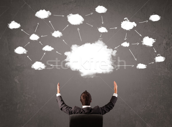 Businessman sitting with cloud technology above his head Stock photo © ra2studio