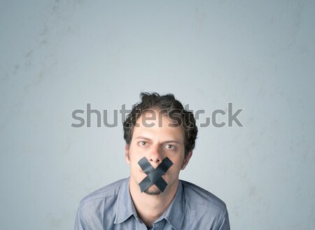 Young man with glued mouth  Stock photo © ra2studio