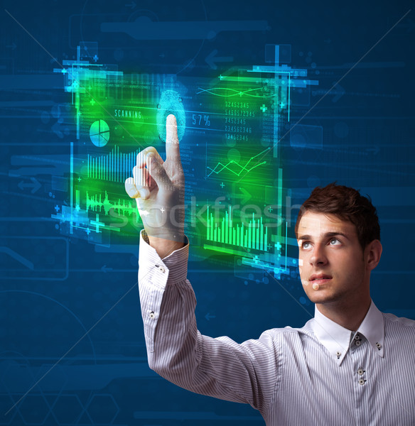 Young businessman pressing modern technology panel with finger p Stock photo © ra2studio