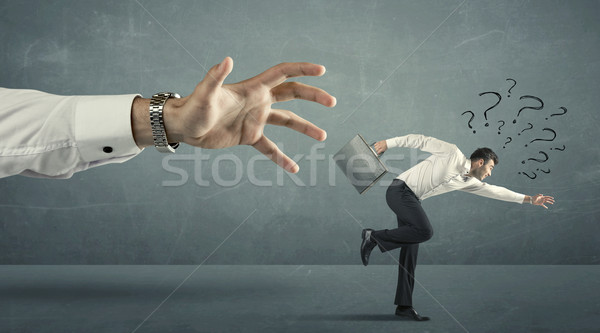 Empresário corrida longe grande mão pontos de interrogação Foto stock © ra2studio