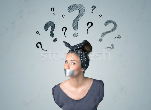 Young woman with glued mouth and question mark symbols Stock photo © ra2studio