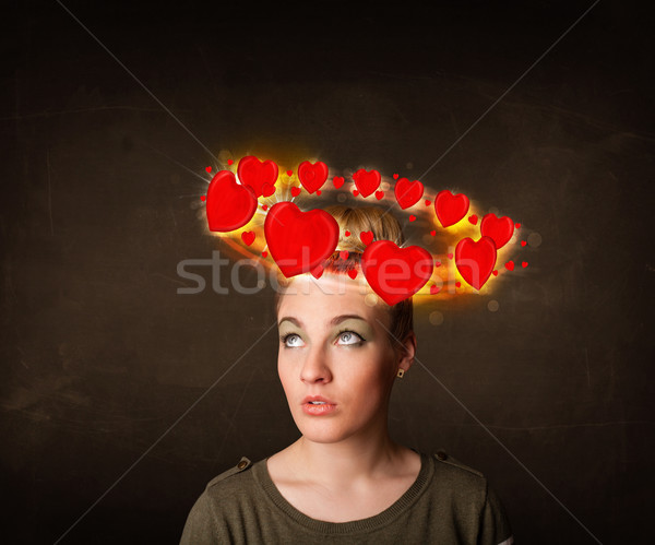 teenager girl with heart illustrations circleing around her head Stock photo © ra2studio