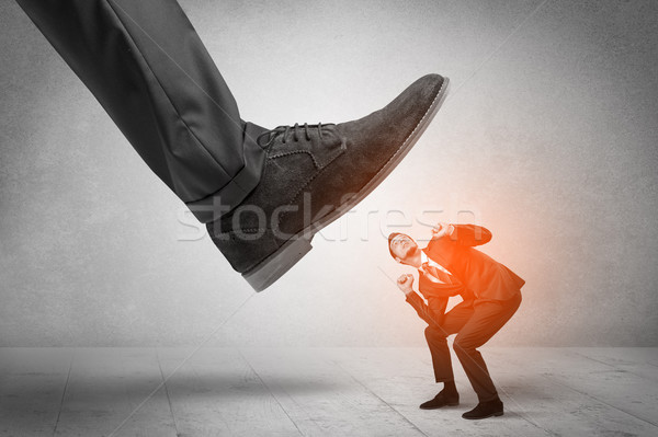 Large foot stepping down small man Stock photo © ra2studio