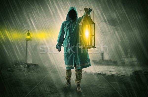 Man coming with lantern at coast concept Stock photo © ra2studio