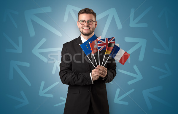 Cheerful boy standing with flag and arrows around Stock photo © ra2studio