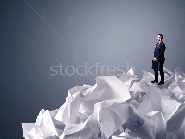 Businessman standing on crumpled paper Stock photo © ra2studio