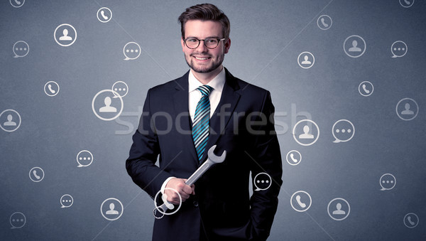 Handsome man standing with tool on his hand Stock photo © ra2studio