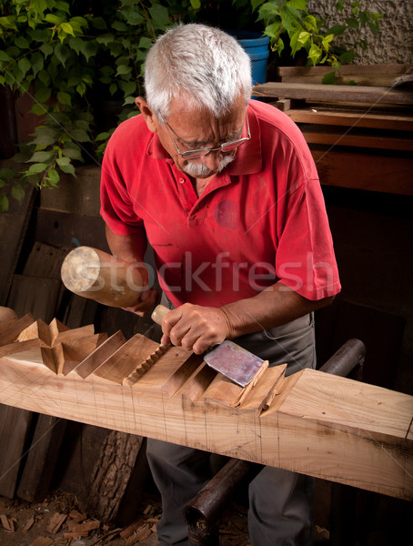 Old woodcarver working with mallet Stock photo © ra2studio