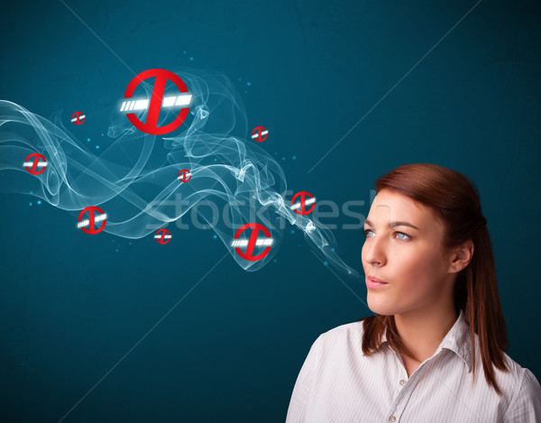 Young woman smoking dangerous cigarette with no smoking signs Stock photo © ra2studio