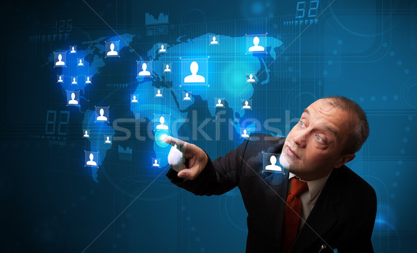 Businessman choosing from social network map Stock photo © ra2studio