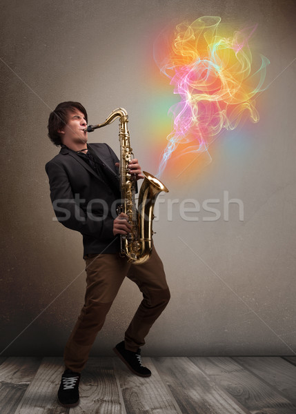 Attractive musician playing on saxophone with colorful abstract  Stock photo © ra2studio