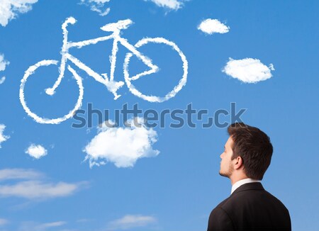 Joven mirando bicicleta nubes cielo azul jóvenes Foto stock © ra2studio