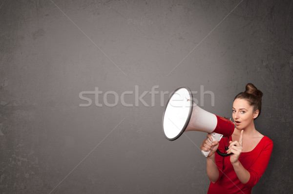 Stock photo: Girl shouting into megaphone on copy space background