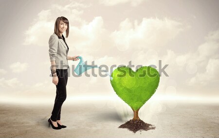 Stock photo: Businesswoman on rock mountain with a tree