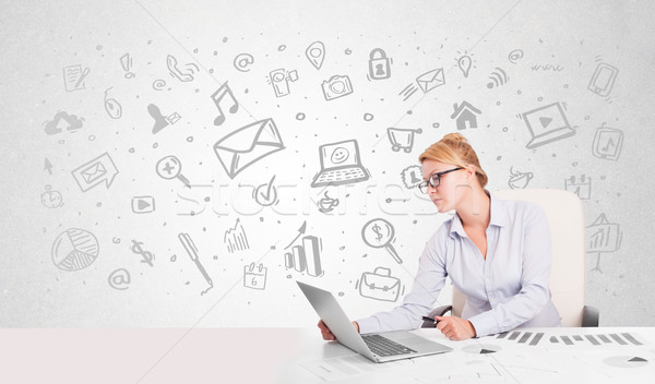 Business woman sitting at table with hand drawn media icons  Stock photo © ra2studio
