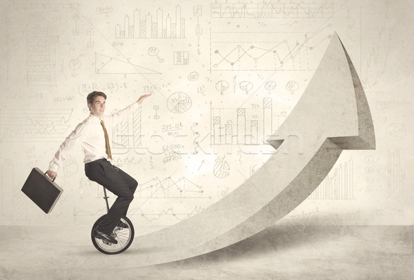 Happy business man riding a monocycle up on an arrow  Stock photo © ra2studio