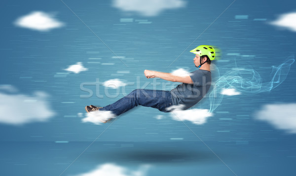 Stock photo: Funny racedriver young man driving between clouds concept