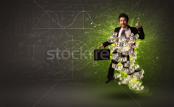 Cheerful businesman jumping with dollar banknotes around him Stock photo © ra2studio